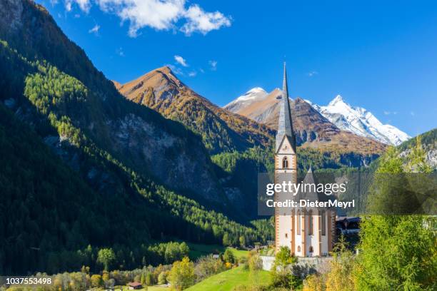 heiligenblut - st vincent church against grossglockner mountain, austria - carinthia stock pictures, royalty-free photos & images