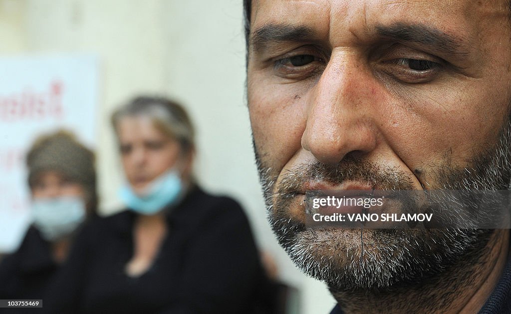 Ramaz Aronia (R), 51, a Georgian refugee