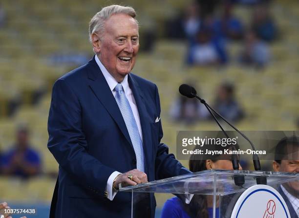 Retired Dodgers broadcaster Vin Scully, left speaks during a pregame ceremony honoring language broadcaster Jaime Jarrin inducting him into the...