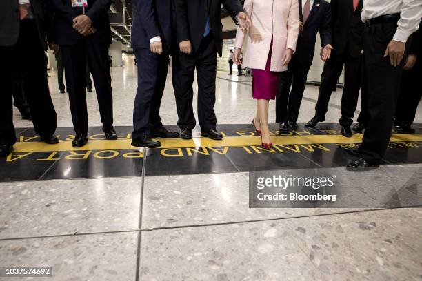 Carrie Lam, Hong Kong's chief executive, center right, steps over the border line into China during a tour at West Kowloon Station, which houses the...