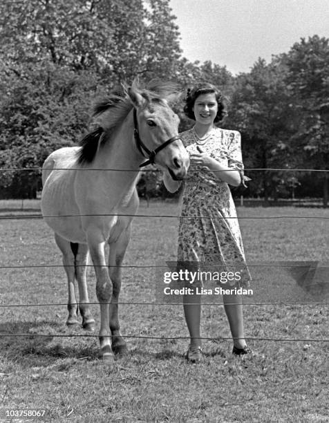 Princess Elizabeth pictured beside a horse in the garden at Windsor Castle, Berkshire, Great Britain, 30 May 1944.