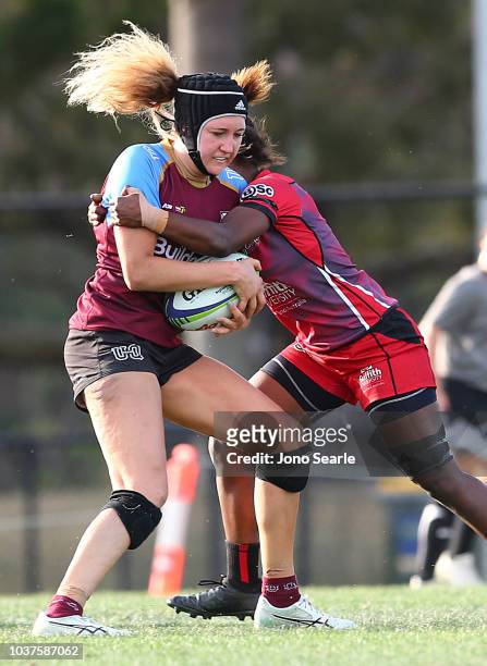 Bodil van Wijnbergen of University of Queensland is tackled during the Aon Uni 7s match between Griffith University and University of Queensland on...