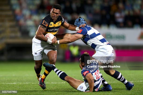 Seta Tamanivalu of Taranaki beats the tackles of TJ Faiane and Marcel Renata of Auckland during the round six Mitre 10 Cup match between Taranaki and...