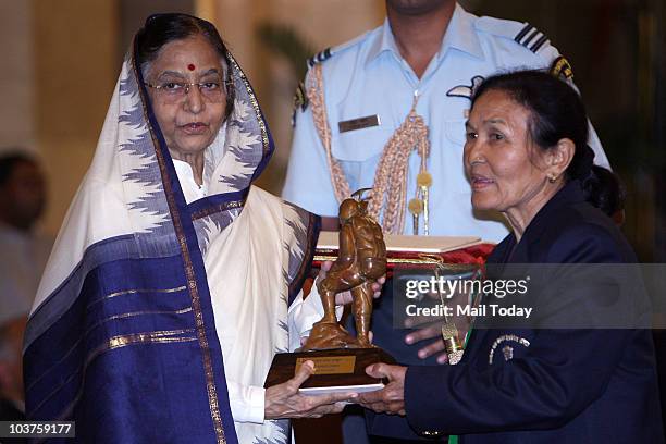 President Pratibha Patil presents the Tenzing Norgay National Adventure award to Chandraprabha Aitwal during a function at Rashtrapati Bhavan in New...