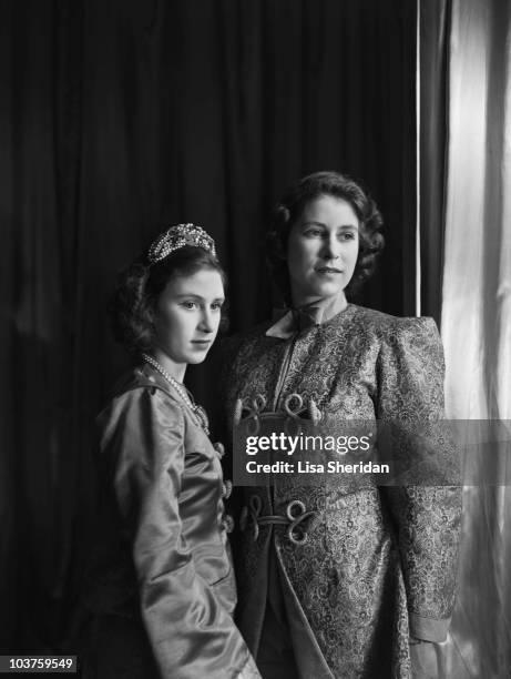 Princess Elizabeth and Princess Margaret , both in costume, pictured ahead of a royal pantomime production of 'Aladdin' at Windsor Castle, Berkshire,...