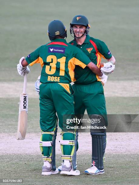 Simon Milenko and Clive Rose of the Tigers celebrate after winning the JLT One Day Cup match between Queensland and Tasmania at Riverway Stadium on...