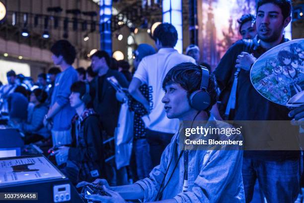 An attendee plays a Sony Corp. PlayStation video game at the Sony Interactive Entertainment Inc. Booth during the Tokyo Game Show in Chiba, Japan, on...