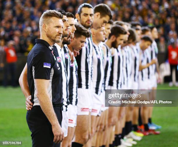 Magpies head coach Nathan Buckley lines up for the national anthem during the AFL Preliminary Final match between the Richmond Tigers and the...