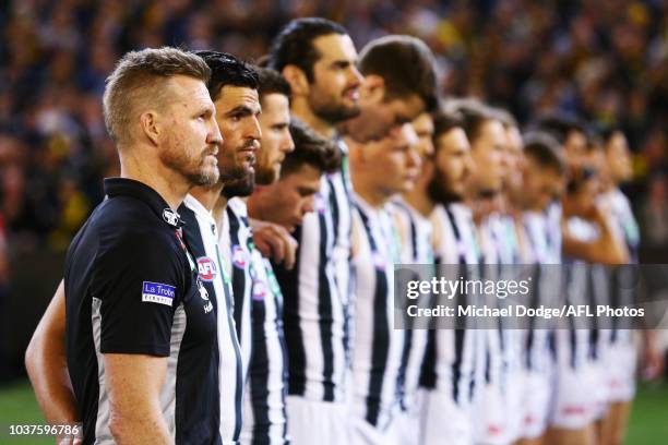 Magpies head coach Nathan Buckley lines up for the national anthem during the AFL Preliminary Final match between the Richmond Tigers and the...