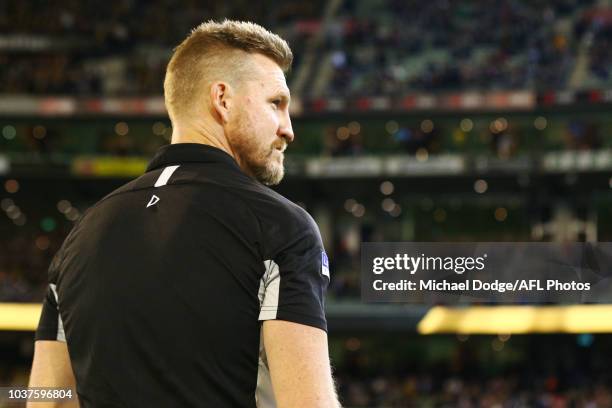 Magpies head coach Nathan Buckley looks on before the national anthem during the AFL Preliminary Final match between the Richmond Tigers and the...