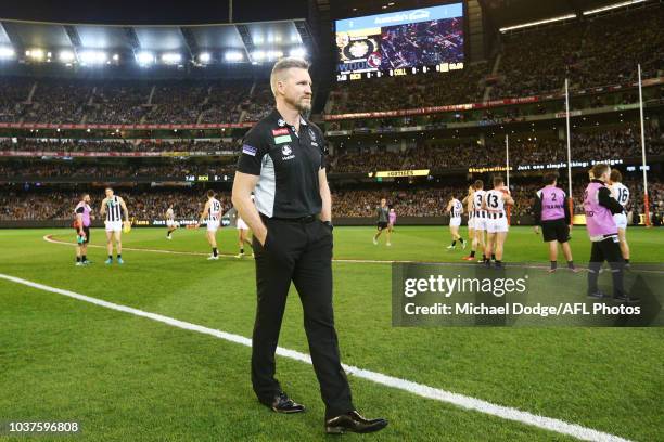 Magpies head coach Nathan Buckley looks on before the national anthem during the AFL Preliminary Final match between the Richmond Tigers and the...