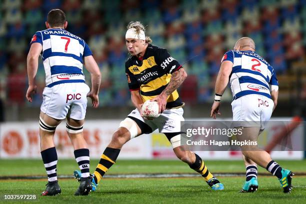 Jarrad Hoeata of Taranaki attempts to evade Dalton Papalii and Robbie Abel of Auckland during the round six Mitre 10 Cup match between Taranaki and...