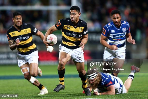 Stephen Perofeta of Taranaki beats the tackle of Evan Olmstead of Auckland during the round six Mitre 10 Cup match between Taranaki and Auckland at...