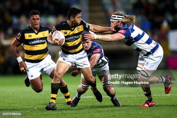Stephen Perofeta of Taranaki beats the tackle of Evan Olmstead of Auckland during the round six Mitre 10 Cup match between Taranaki and Auckland at...