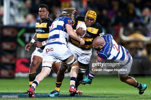 Pita Sowakula of Taranaki is tackled by Evan Olmstead and Robbie Abel of Auckland during the round six Mitre 10 Cup match between Taranaki and...