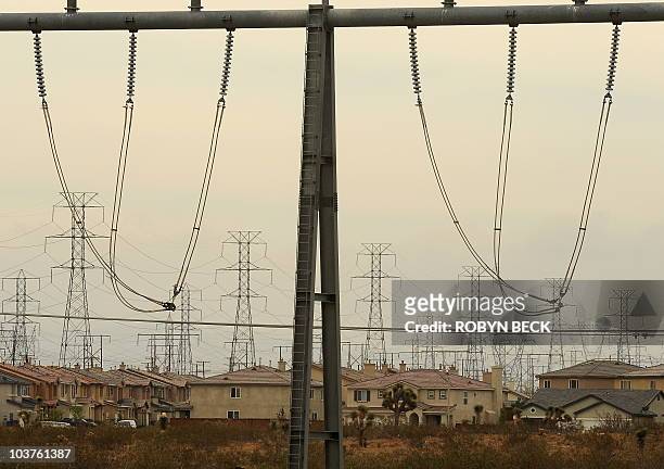 Homes on newer housing developments are located near powerlines in the high desert city of Victorville, California on June 15 the first day of a...