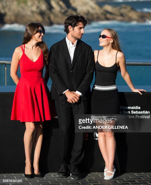 French actresses Laetitia Casta and Lily-Rose Depp flank French director, writer and actor Louis Garrel as they pose during a photocall to promote...