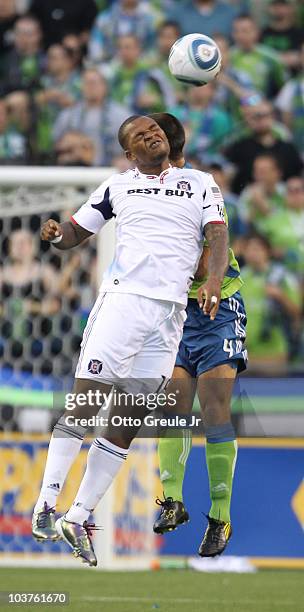 Collins John of the Chicago Fire heads the ball against Patrick Ianni of the Seattle Sounders FC on August 28, 2010 at Qwest Field in Seattle,...