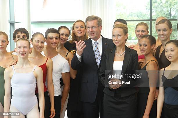 German President Christian Wulff, his wife First Lady Bettina , and Minister for Science and Arts of Saxony Sabine von Schorlemer pose with students...