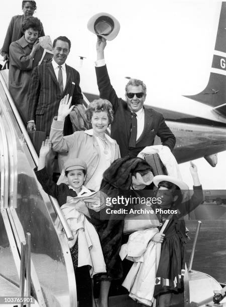 American actress Lucille Ball and her husband Desi Arnaz with their children Lucie and Desi Jr., circa 1959. Behind them is actor William Holden .