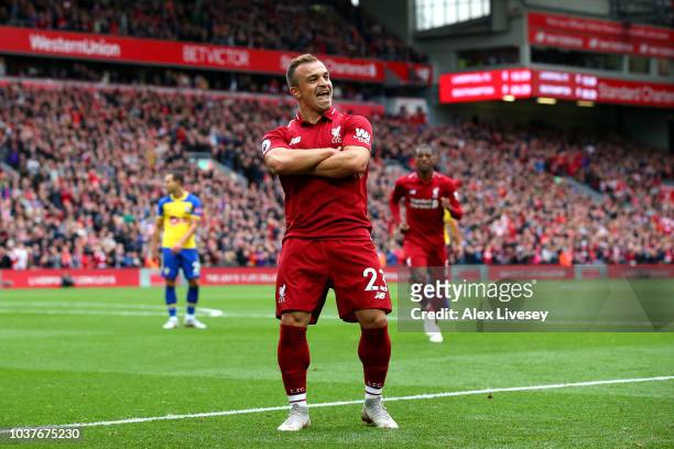 Xherdan Shaqiri of Liverpool celebrates after he provides the assist for Liverpool's first goal, an own goal by Wesley Hoedt of Southampton during...