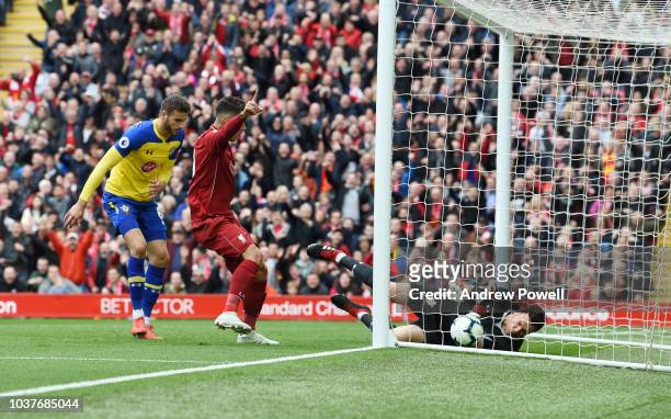 Xherdan Shaqiri of Liverpool shoots the ball Goes in off southampton defender Wesley Hoedt during the Premier League match between Liverpool FC and...