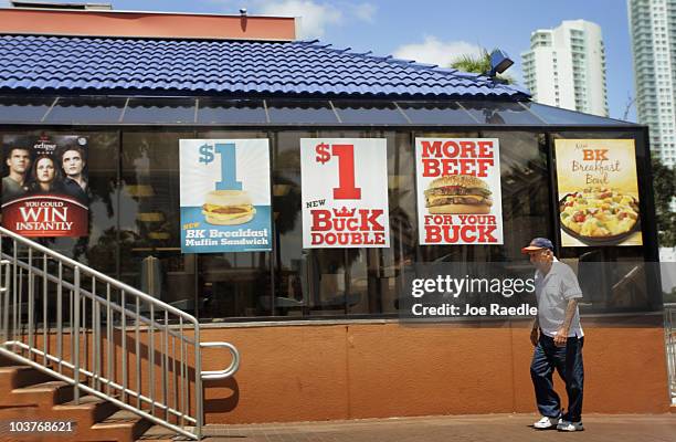 Man walks in front of a Burger King restaurant as reports indicate the company may be considering a sale of itself on September 1, 2010 in Miami,...