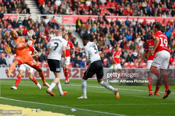 Darren Randolph of Middlesbrough punches the ball away from Oli McBurnie and Martin Olsson of Swansea City during the Sky Bet Championship match...