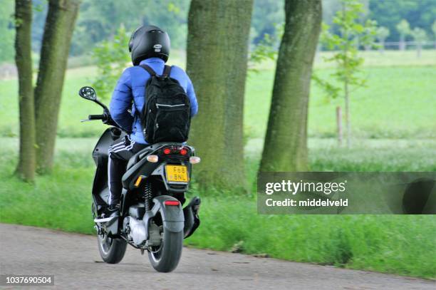 passing moped - moped stock pictures, royalty-free photos & images