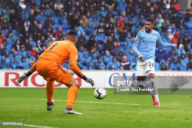 Riyad Mahrez of Manchester City scores his team's fourth goal past Neil Etheridge of Cardiff City during the Premier League match between Cardiff...