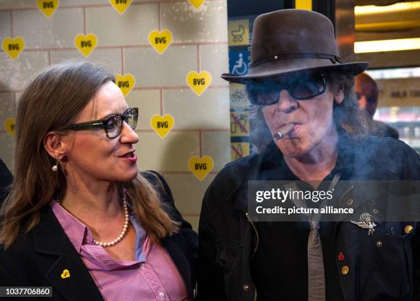 German singer Udo Lindenberg smokes while standing next to Sigrid Evelyn Nikutta, CEO of Berliner Verkehrsbetriebe , in the subway station near the...