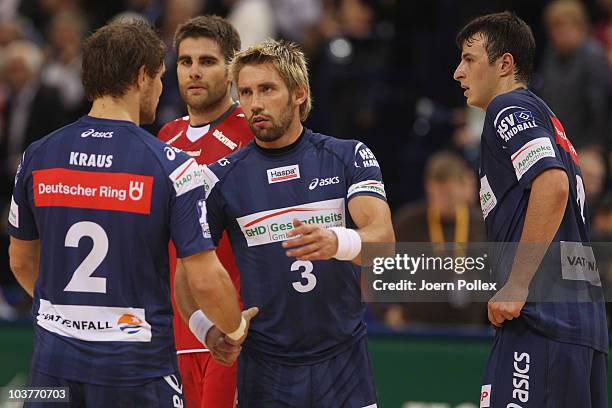 Michael Kraus , Stefan Schroeder and Domagoj Duvnjak of Hamburg shake hands after the Toyota Handball Bundesliga match between HSV Hamburg and HSG...