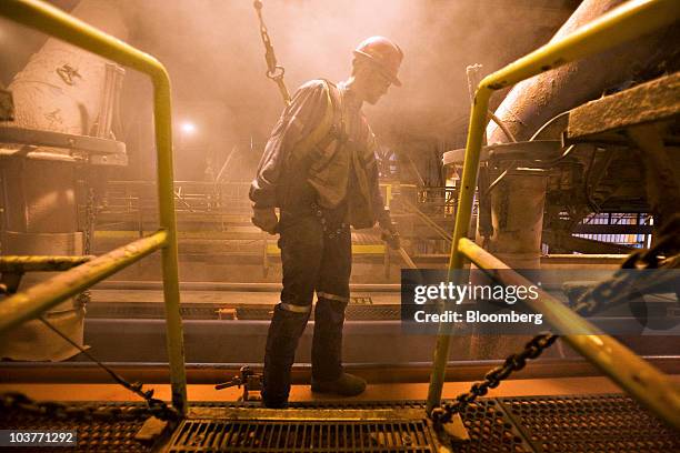 Dean Puetz, a mill operator at the Potash Corp. Of Saskatchewan Lanigan mine, prepares railcars for transferring potash at the company's facility in...