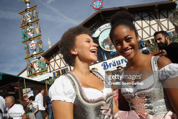 Two young women wearing dirndls attend the opening day of the 2018 Oktoberfest beer festival on September 22, 2018 in Munich, Germany. This year's...