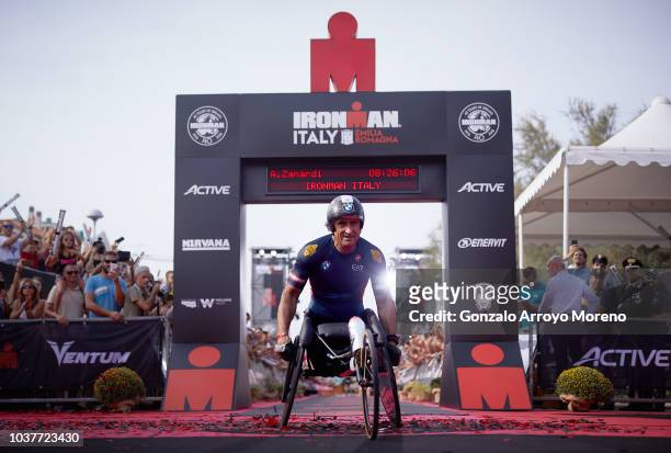 Former Italian Formula One and athlete Alex Zanardi arrives at the finish line beating a new record during the biking course of Ironman Emilia...
