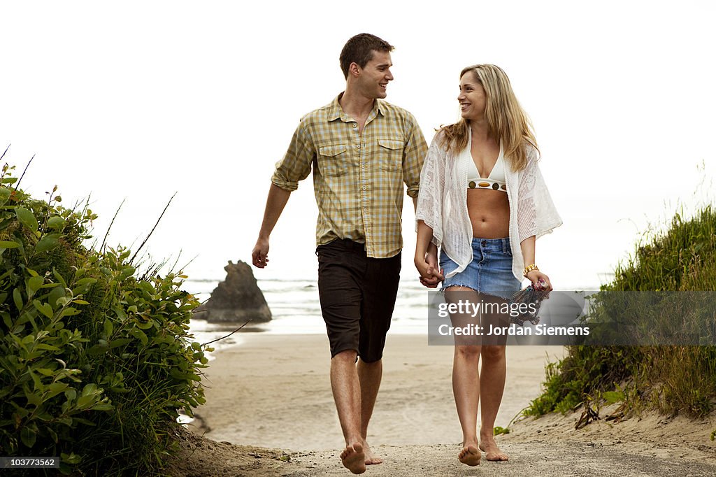 Couple smiling while at the beach.