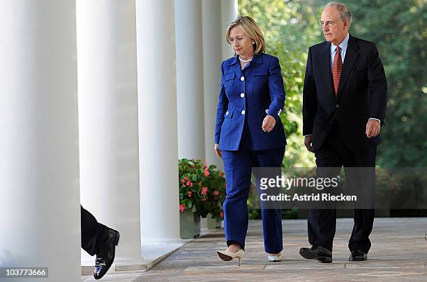 Secretary of State Hillary Clinton and George Mitchell, Special Envoy to the Middle East, follow U.S. President Barack Obama as he arrives to deliver...