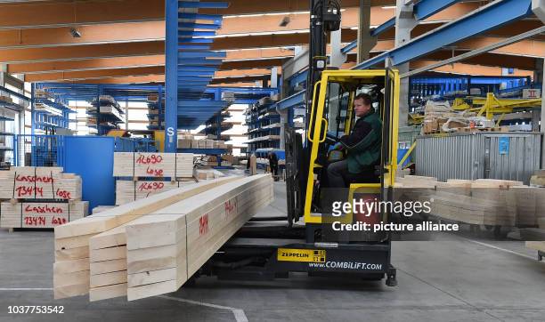 Forklifter moves fitted bars at the company Opitz Holzbau GmbH in Neuruppin, Germany, 30 March 2016. The 65 employees of the company are making roof...