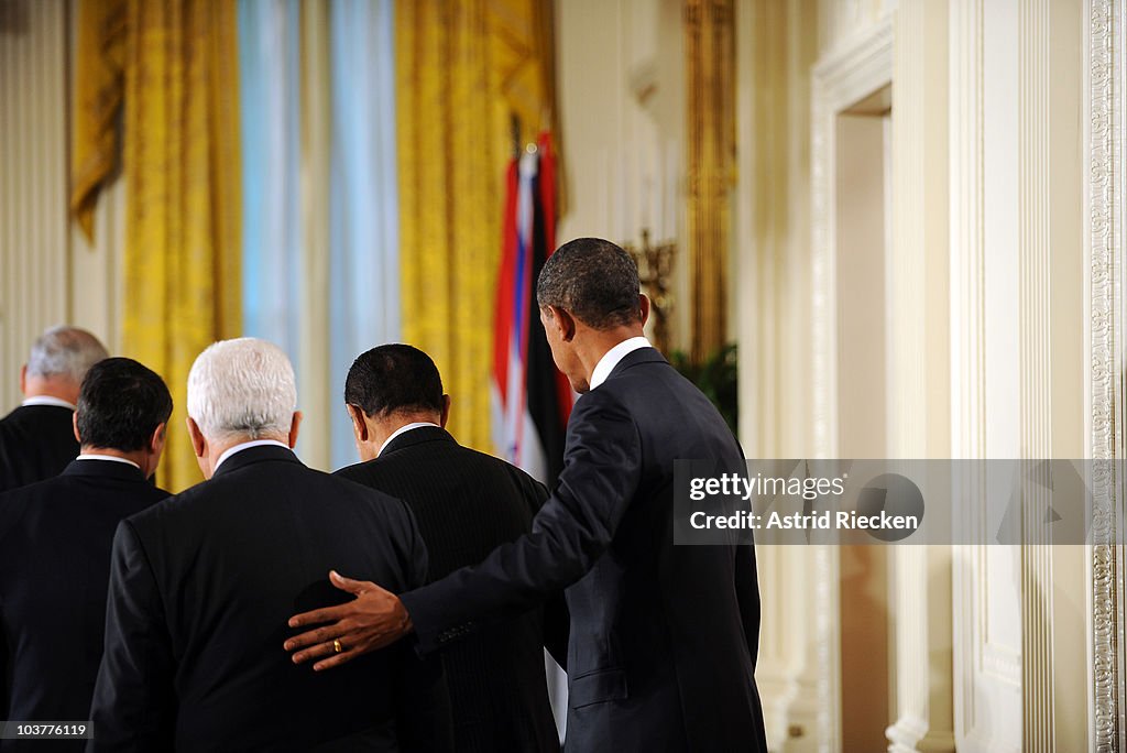 Obama Rasing His Hand U.S. President Barack Obama puts his hand on the shoulder of... News ...