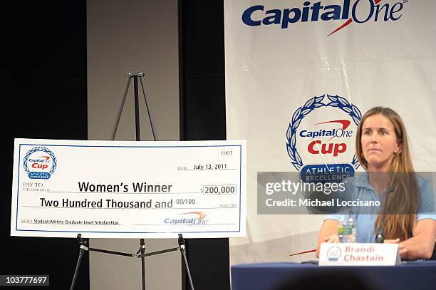 Former professional soccer player Brandi Chastain sits next to the Capital One Cup Women's Winner check during the Division 1 College Sports Award...