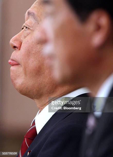 Ichiro Ozawa, former secretary general of the ruling Democratic Party of Japan , left, listens as Naoto Kan, Japan's prime minister and leader of the...