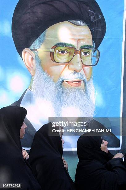 Iranian women wait in front of a picture of Iran's Supreme leader Ayatollah Ali Khamenei, outside the criminal court house in southern Tehran 07...