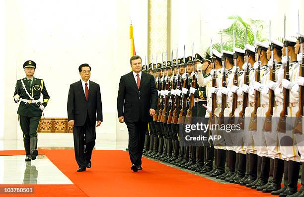Chinese President Hu Jintao and Ukrainian President Viktor Yanukovych review an honour guard during Yanukovych's visit to China in Beijing on...