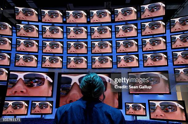 Woman looks at high-definition 3D television screens at Panasonic stand at the 2010 IFA technology and consumer electronics trade fair at Messe...