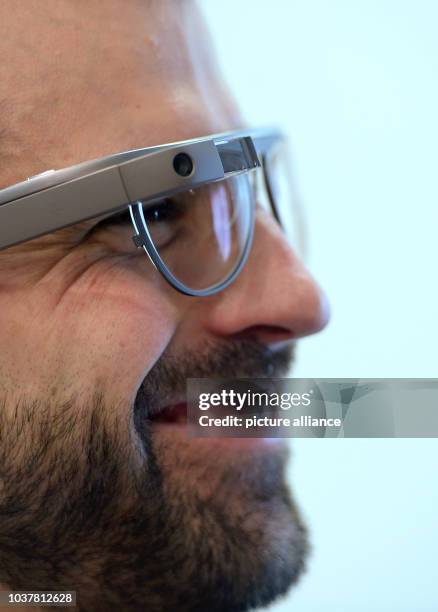 Man wears smart glasses with smart lenses from Google Glass by US-American company Rochester Optical at the Opti optics trade show in Munich,...