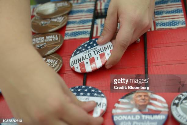 Vendor sells campaign buttons for U.S. President Donald Trump ahead of a rally in Springfield, Missouri, U.S., on Friday, Sept. 21, 2018. Trump vowed...