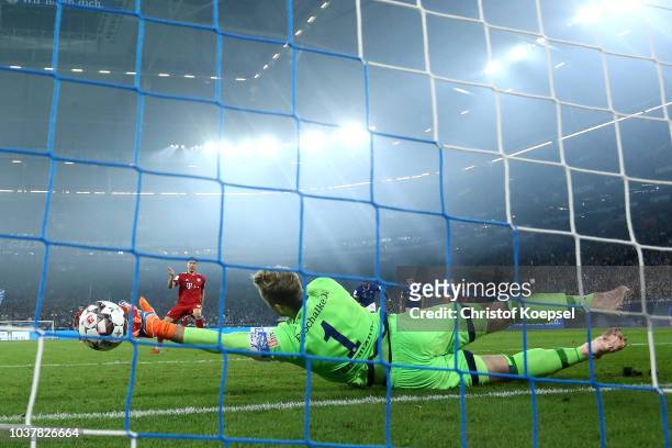 Robert Lewandowski of Bayern Munich scores a penalty for his team's second goal past Ralf Faehrmann of FC Schalke 04 during the Bundesliga match...
