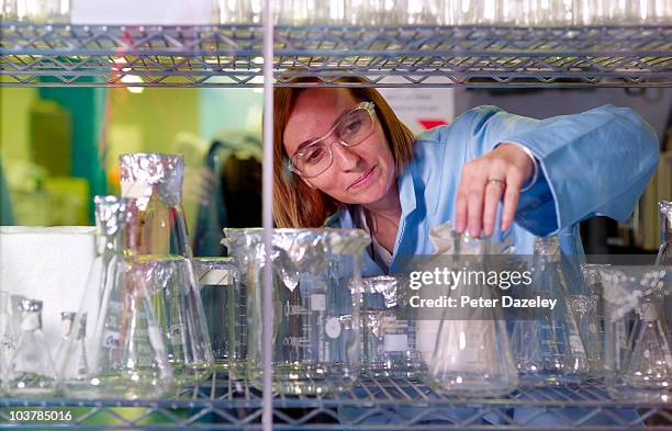 lab technician with scientific equipment - boiling flask stock pictures, royalty-free photos & images