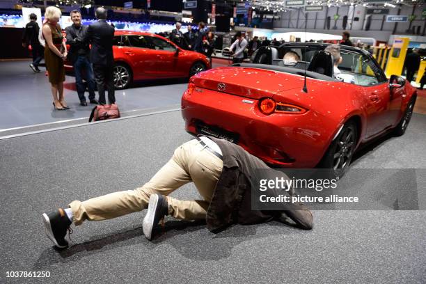 Photographer takes pictures of the new Mazda MX5 at the 85th Geneva International Motor Show at the Palexpo fairground in Geneva, Switzerland, 03...