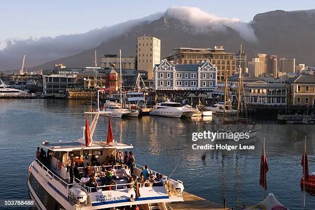 sunset cruise catamaran sea princess with waterfront and table mountain. - princess cruises stock pictures, royalty-free photos & images